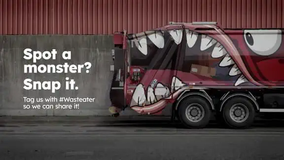 Waste truck with waste eating monster on it