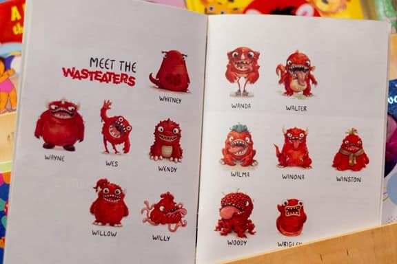 Open wasteater storybook sat on childrens bookshelf, page shown is meet the wasteaters page showing all the wasteaters