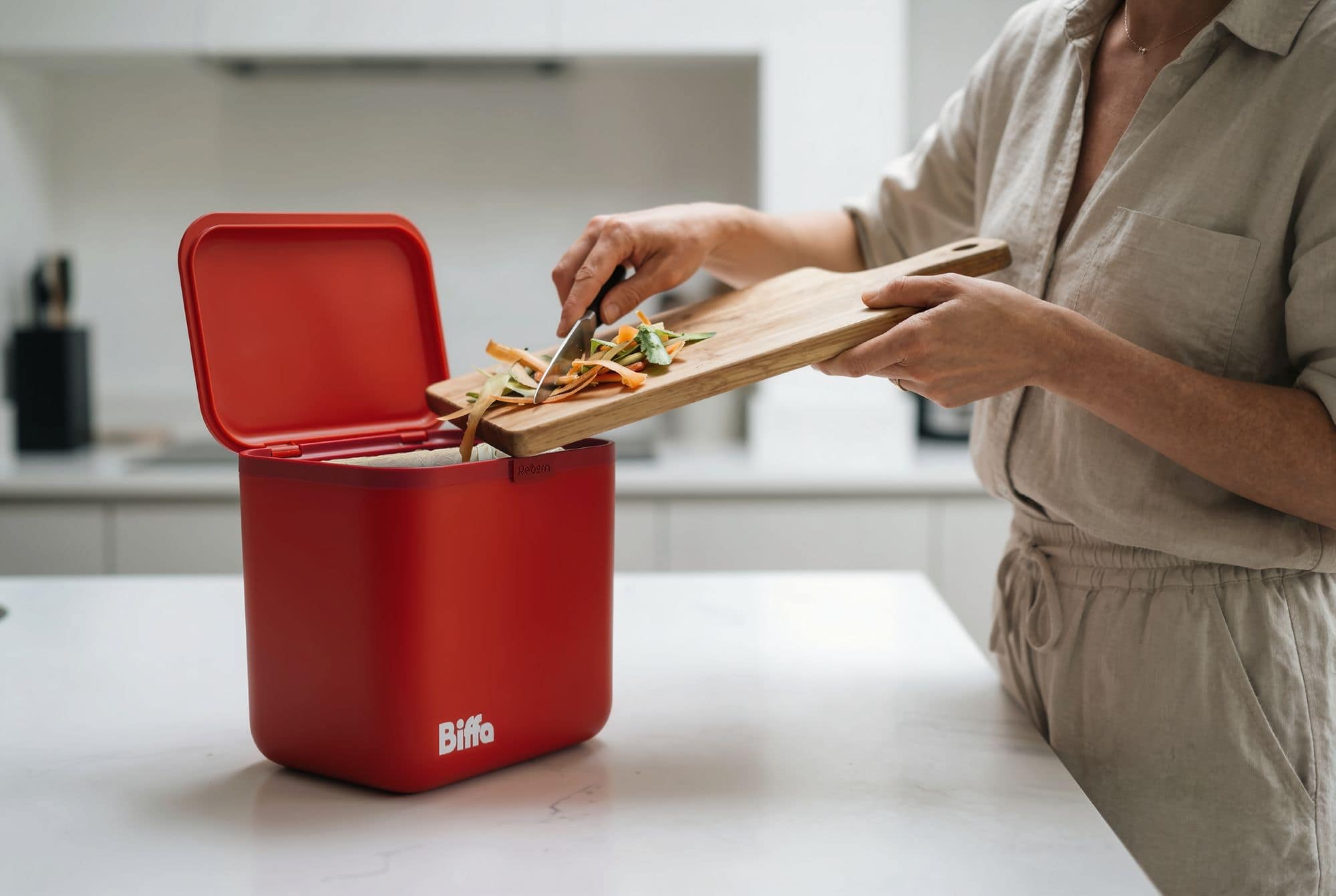 Food getting scrapped into red food caddy