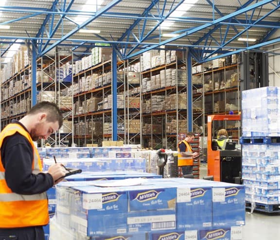 Worker in front of pallet boxes