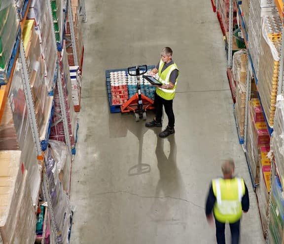 Employees documenting products in warehouse