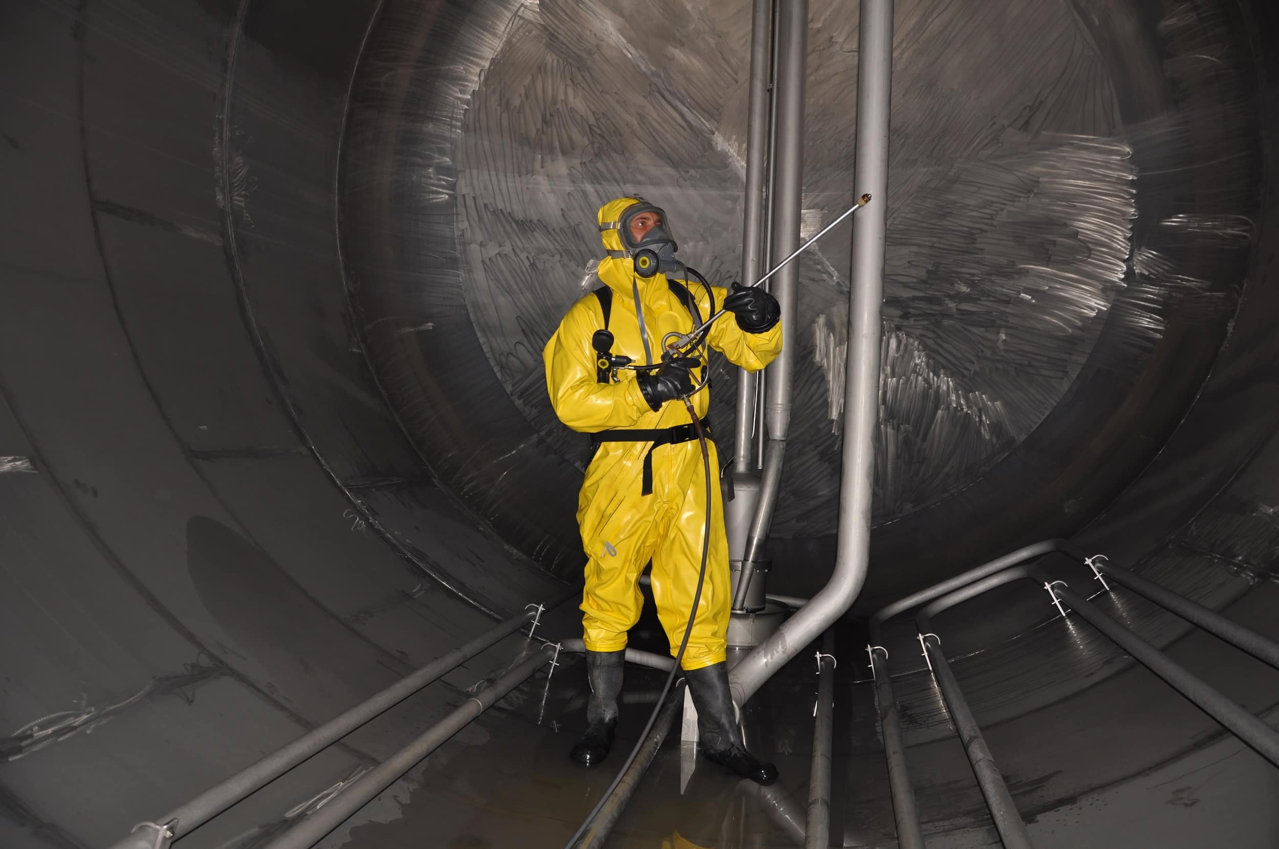 Man in hazmat suit cleaning 