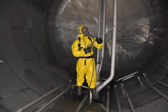 Man in hazmat suit cleaning