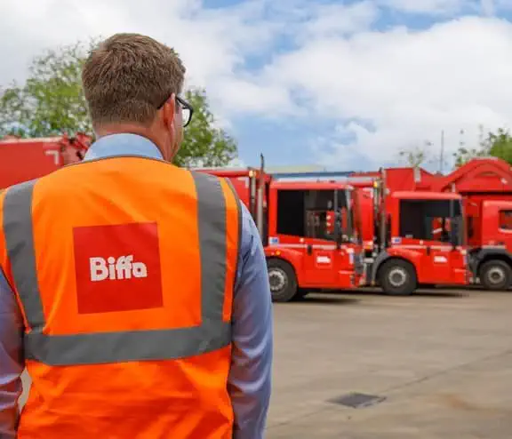 Biffa employee in high vis by vehicles