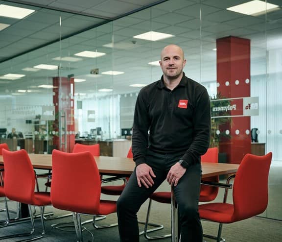 Male employee sitting on office desk