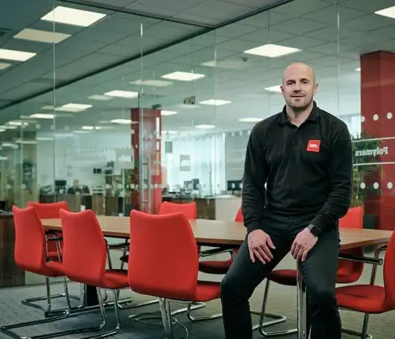 Male employee sitting on office desk