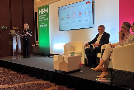 An image of a stage with Debs speaking to a crowd at HFM 2024.