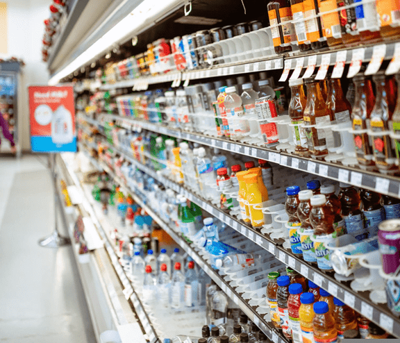 Shopping aisle with bottles on shelves
