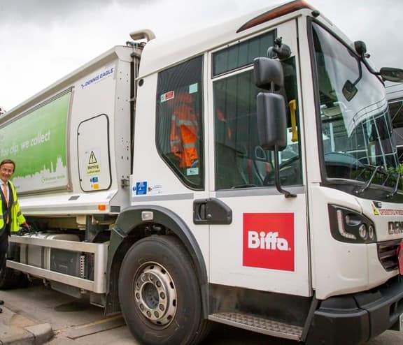 Biffa's top level management standing next to new truck that has recently converted from diesel to HVO