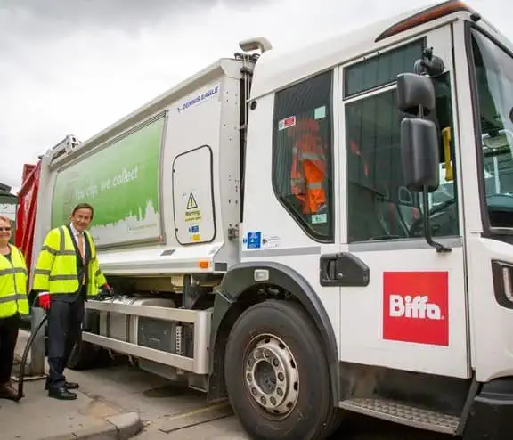 Biffa's top level management standing next to new truck that has recently converted from diesel to HVO