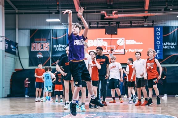 Kid throwing a ball in a basket