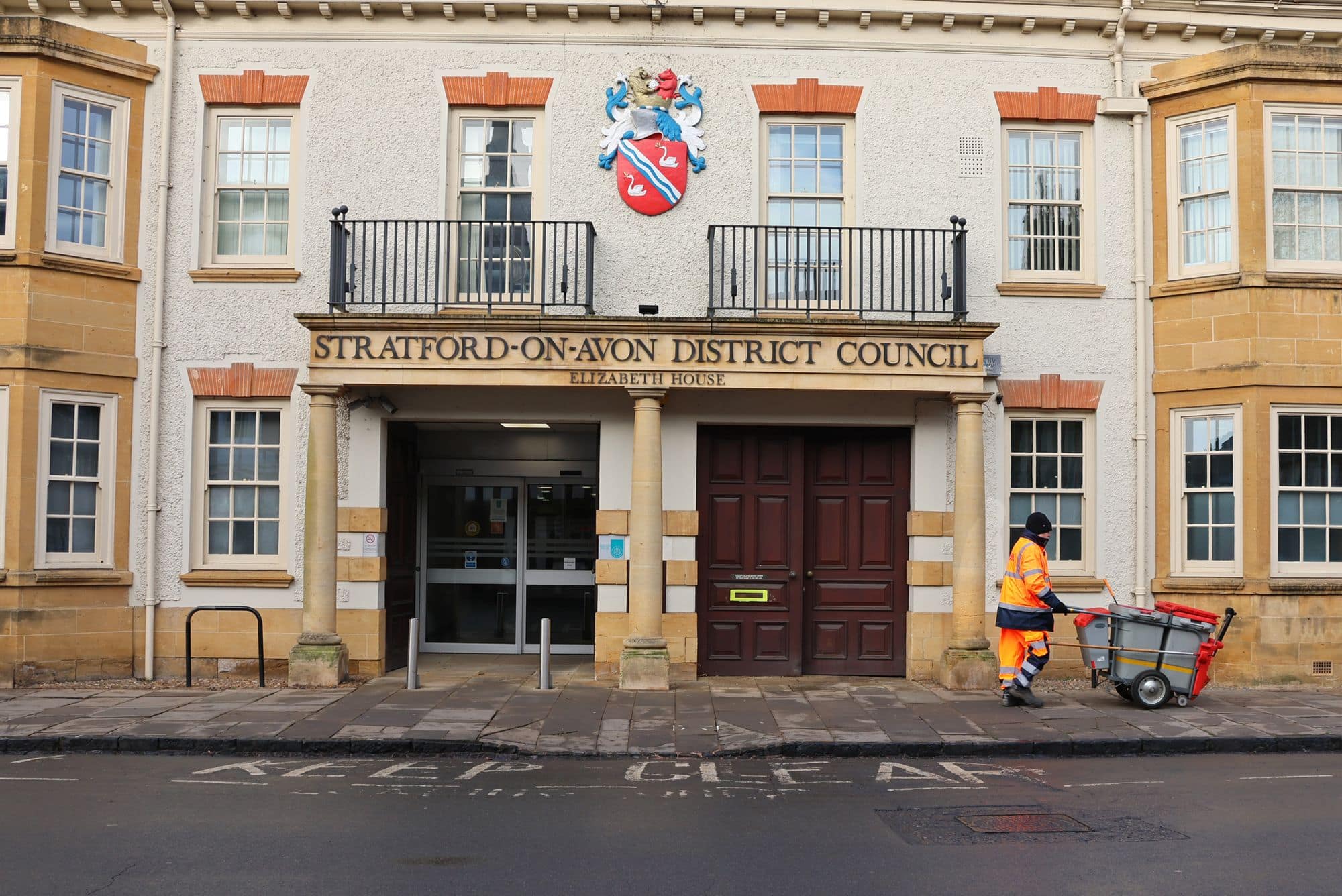 Bin man walking in front of Stratford-on-Avon District Council building