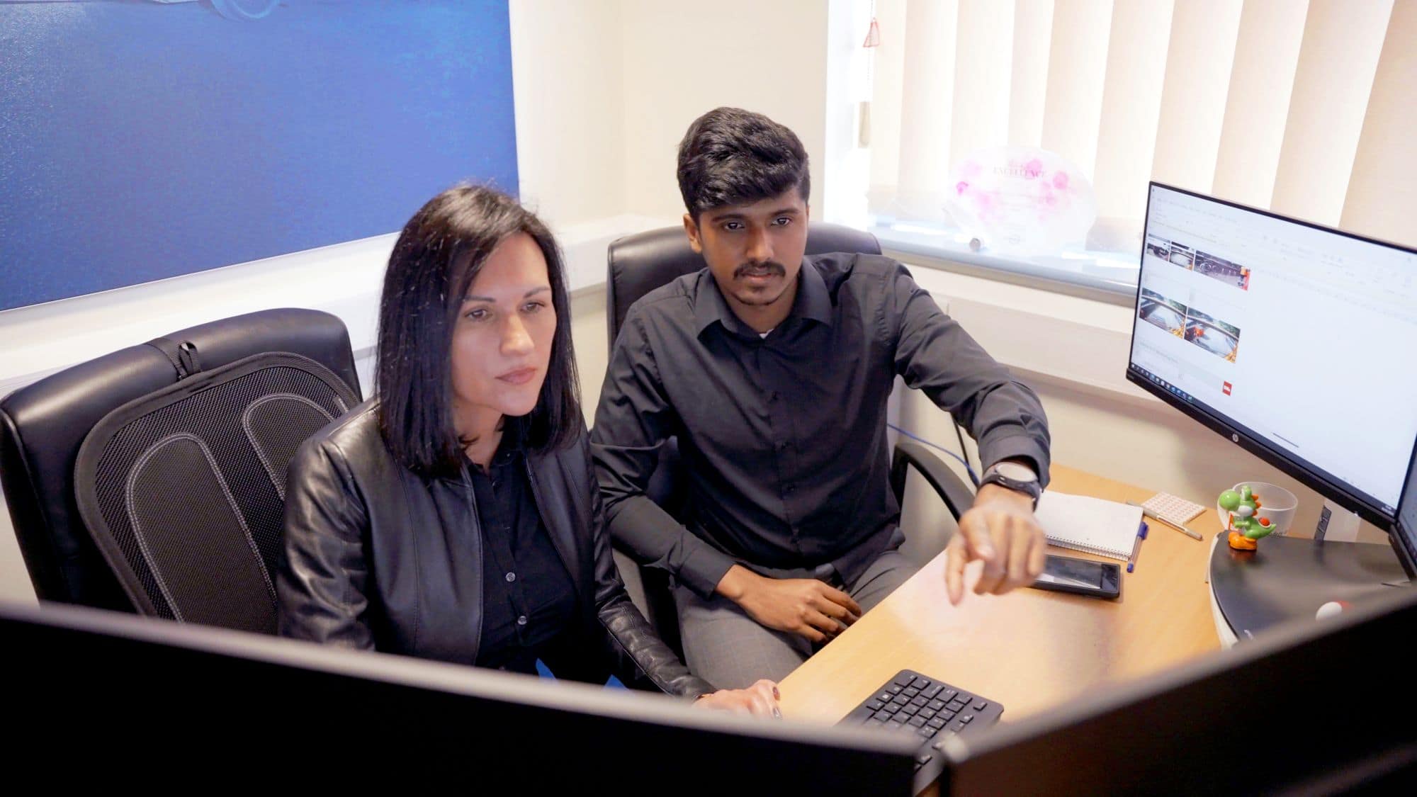Employees discussing data from a screen