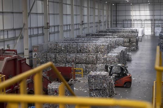 Forklift picking up waste