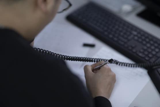 Man helping customer on phone to guide them through regulatory requirements