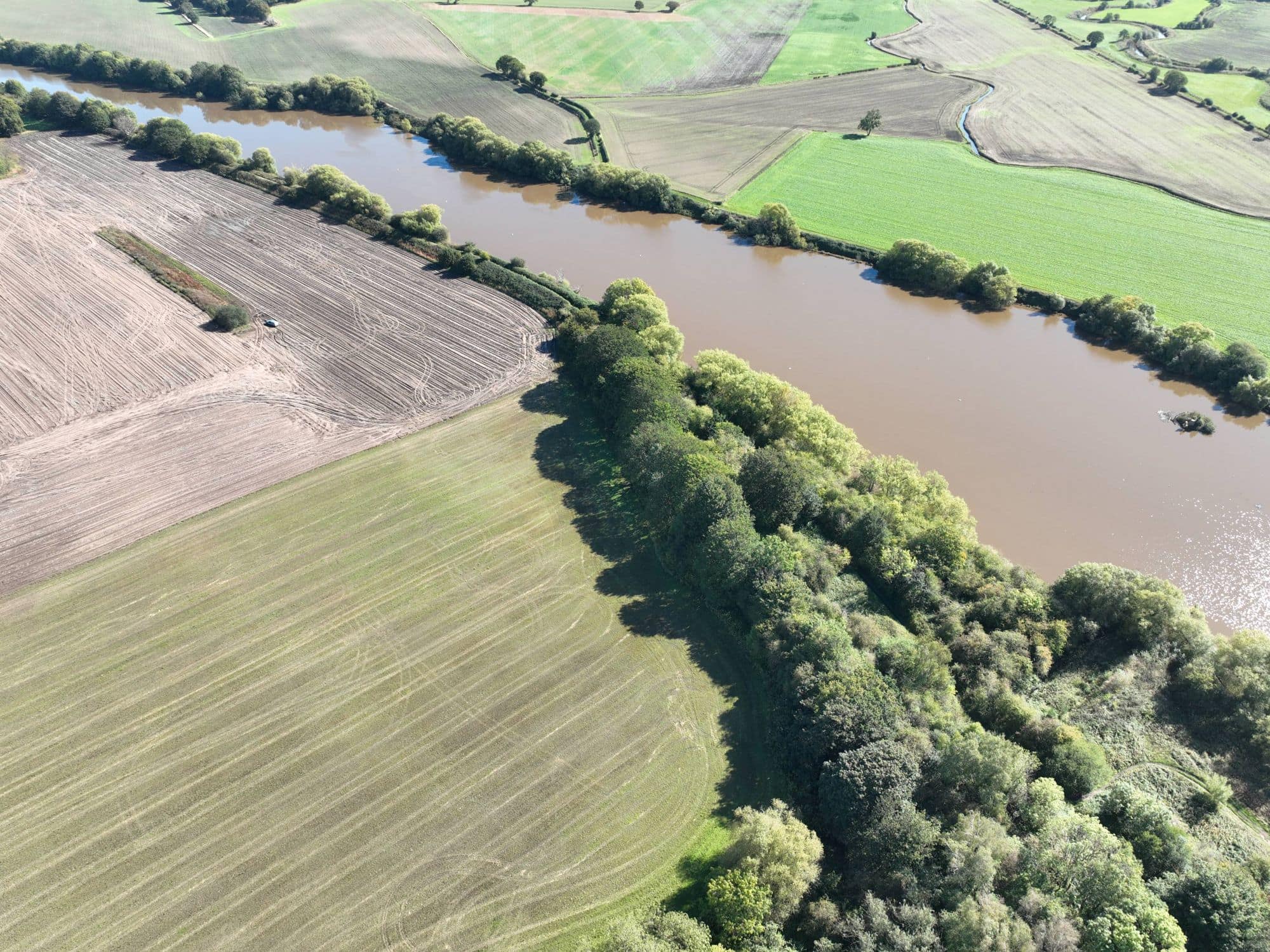 Birds eye view of a river and fields