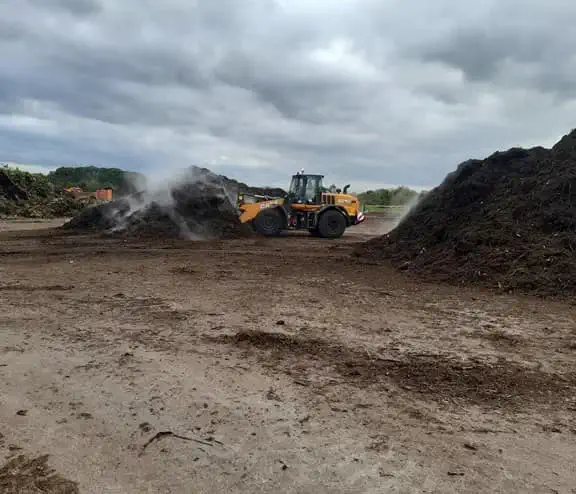Digger moving soil