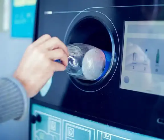 Bottle being inserted into vending machine