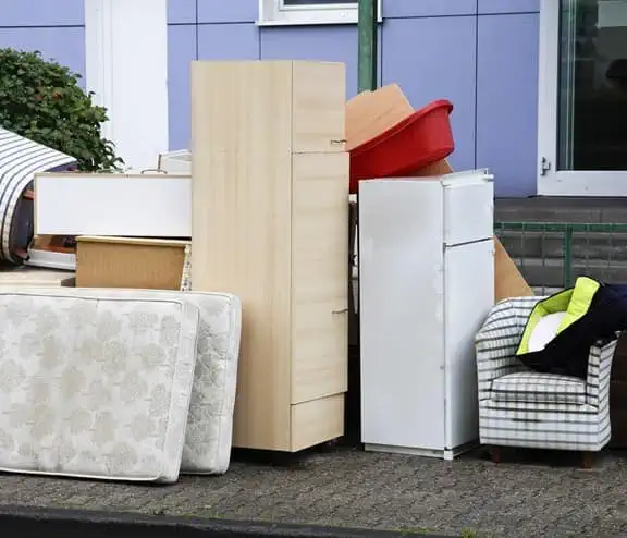 Multiple household items outside building